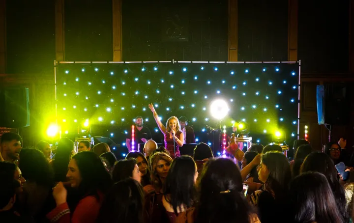 Guests enjoying an illuminated evening dance performance