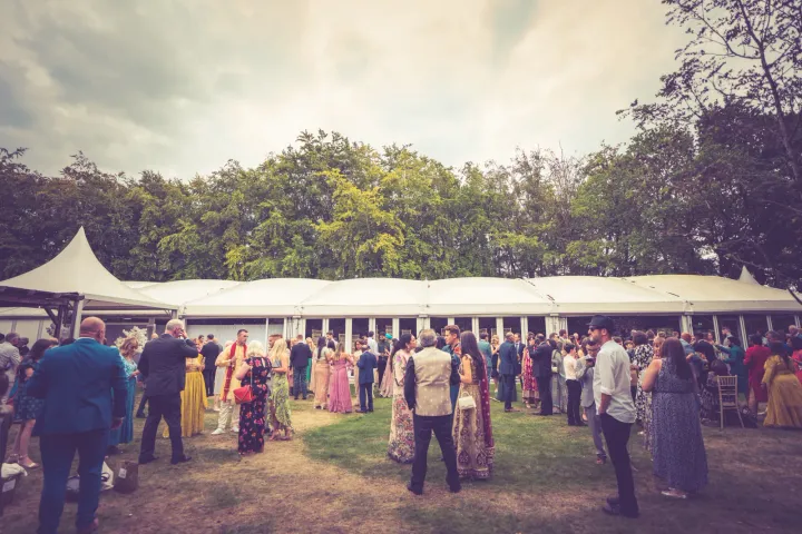 Outdoor reception beside a marquee