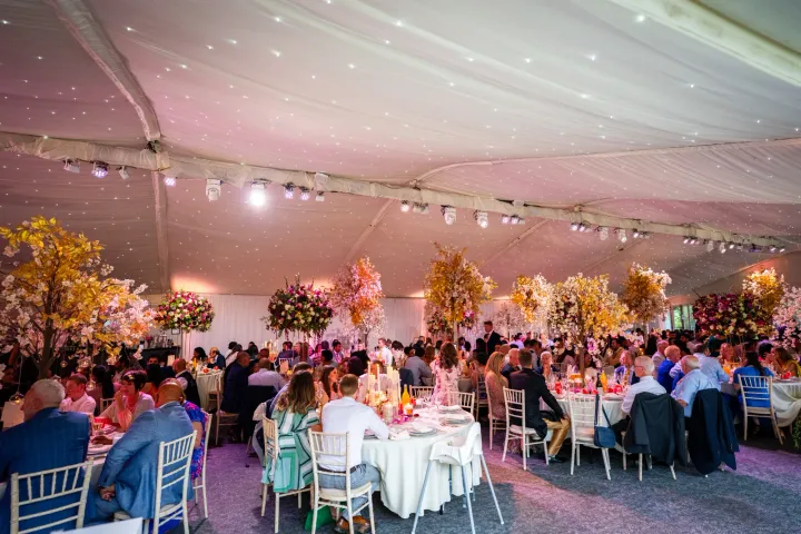 Marquee reception with colourful floral displays
