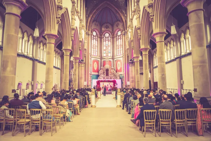Wedding ceremony beneath ornate Gothic arches