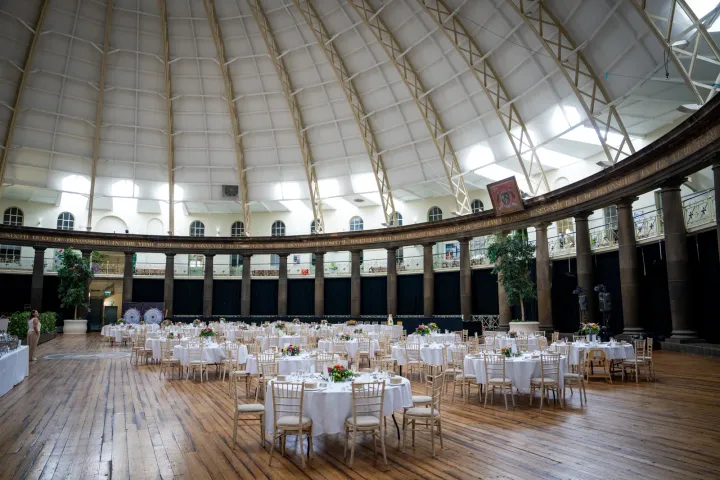 Round reception tables beneath a domed roof