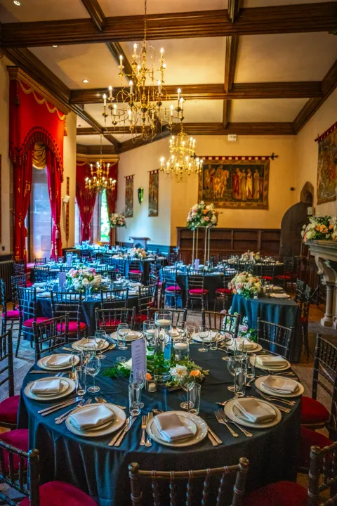 Reception tables with blue linens and colourful chairs