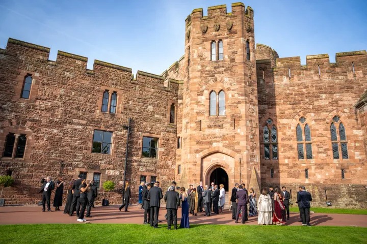 Guests outside a stone castle entrance