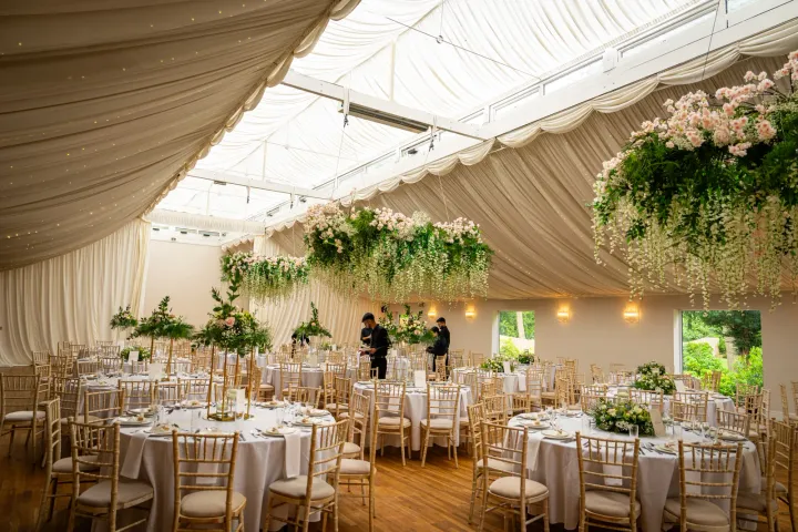 White marquee with hanging floral arrangements