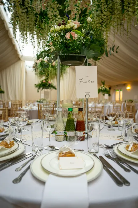 Reception table with white china and botanical styling