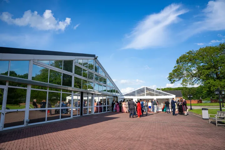 Guests arriving at a glass-fronted venue