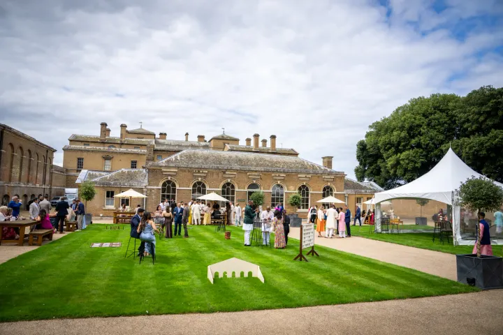 An outdoor reception on a stately house lawn