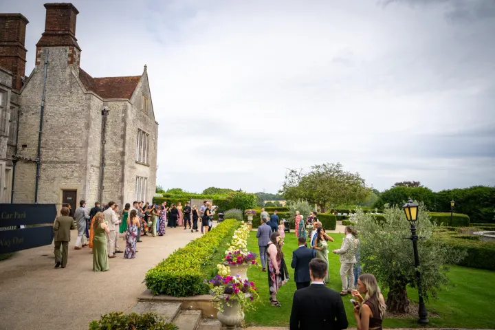 Guests gathering beside a country manor