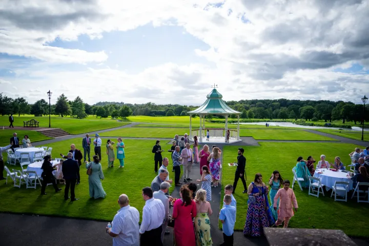 Guests gathering around a garden gazebo