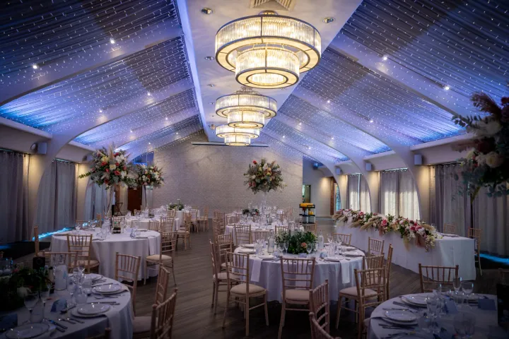 Elegant marquee with chandeliers and floral centrepieces
