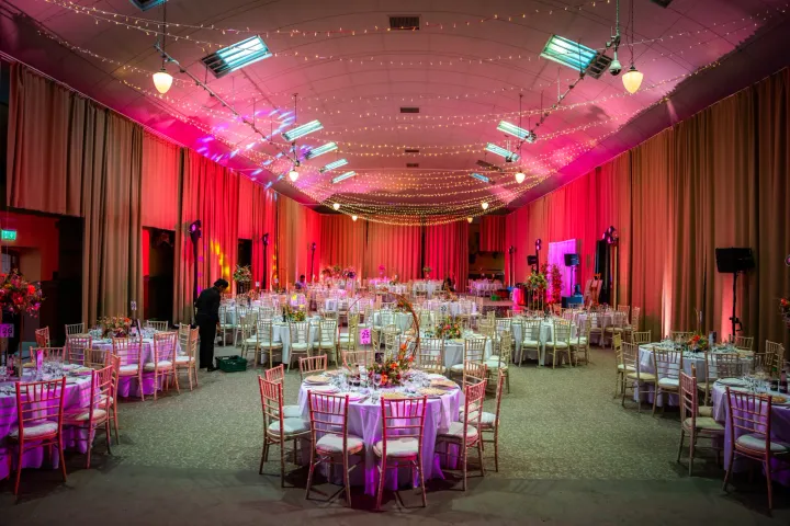 Pink lighting over a decorated wedding hall
