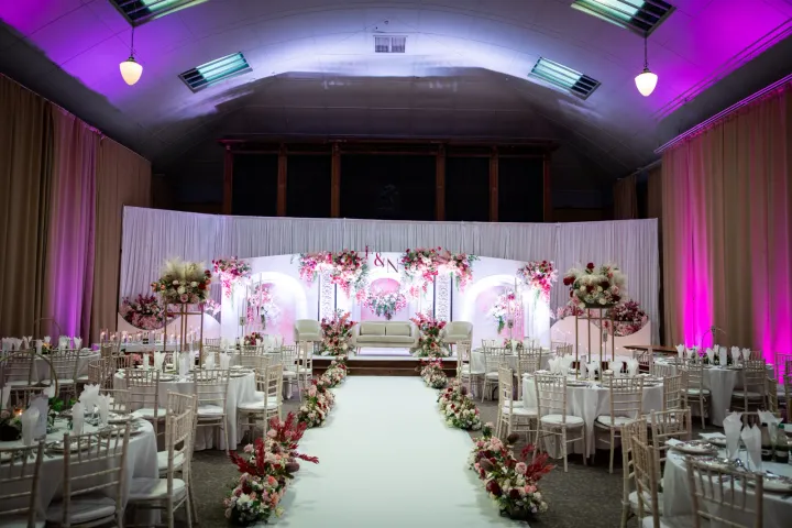 White ceremony aisle facing a floral stage