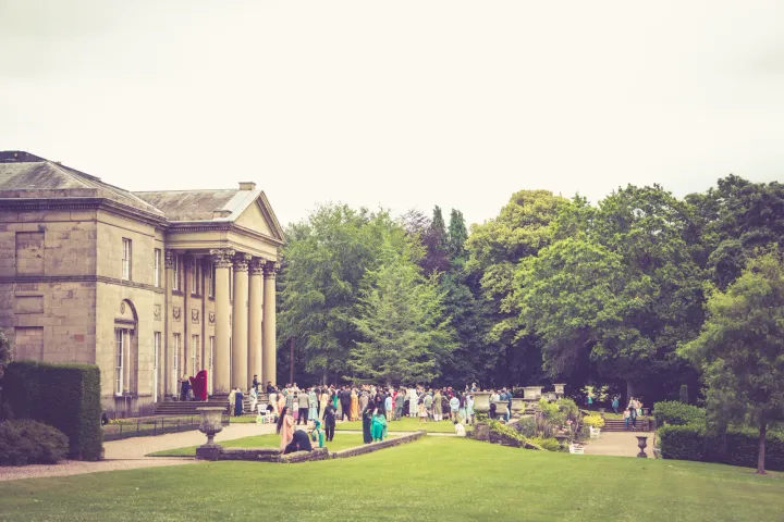 Guests relaxing in stately house gardens