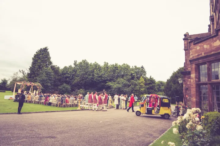 Outdoor gathering beside a historic house