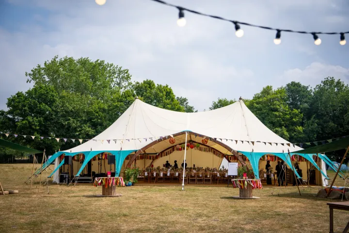 A sailcloth marquee beneath festoon lights