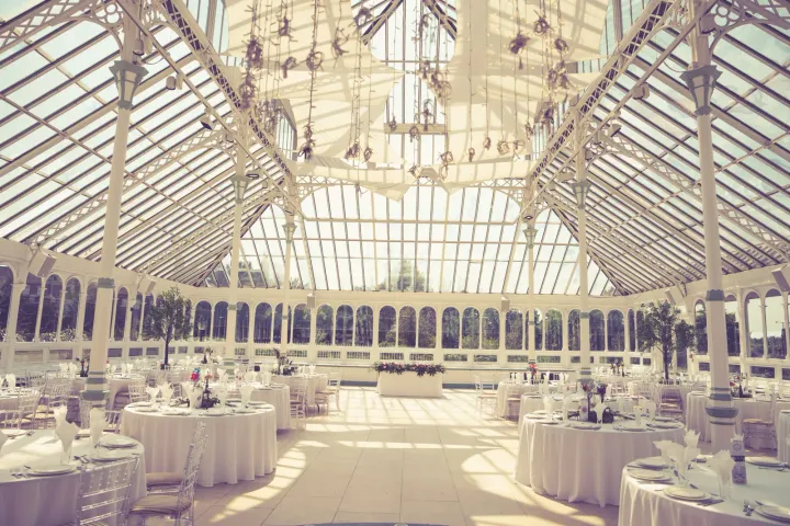 Reception tables beneath a glass conservatory roof
