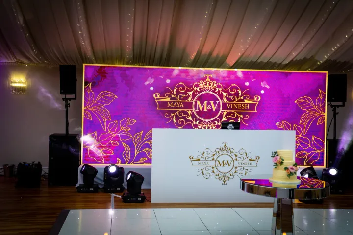 Wedding DJ booth with a colourful backdrop