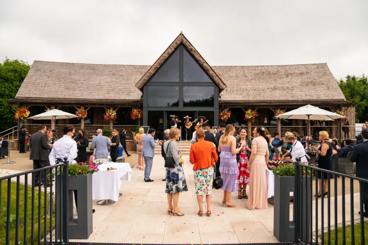 Guests outside a contemporary barn venue