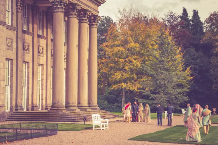 Guests beside a stately house colonnade