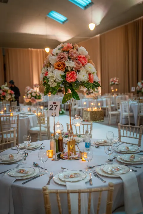 Floral centrepiece above a dressed dining table