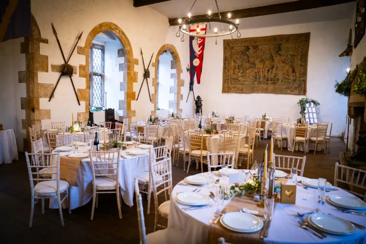 Reception tables in a rustic stone-walled room