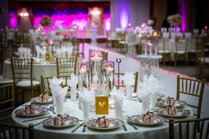 Table settings facing a colourful floral stage