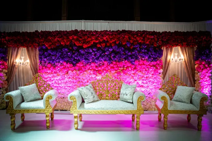 Close view of wedding seating against a flower wall