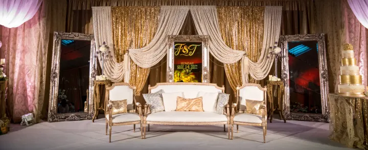 Wedding seating framed by elegant fabric draping