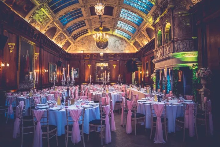 Banquet tables beneath an ornate painted ceiling