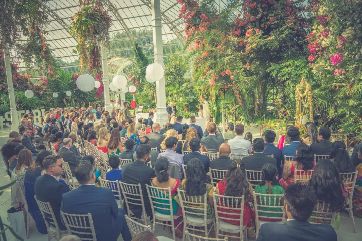 Guests seated for a glasshouse wedding ceremony