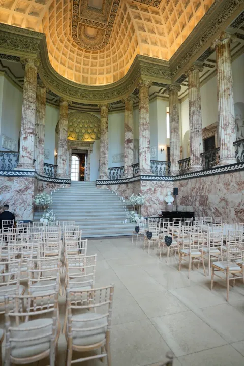 Ceremony seating in a grand stone hall
